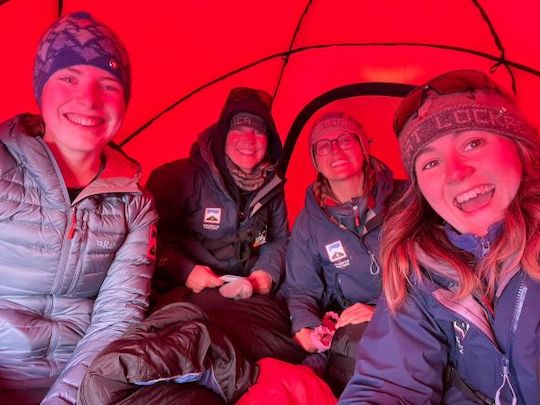 the team inside a red tent