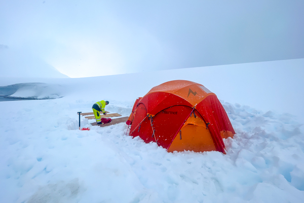 Putting plywood down for base camp