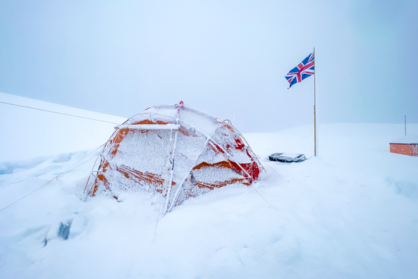 A tent covered in snow