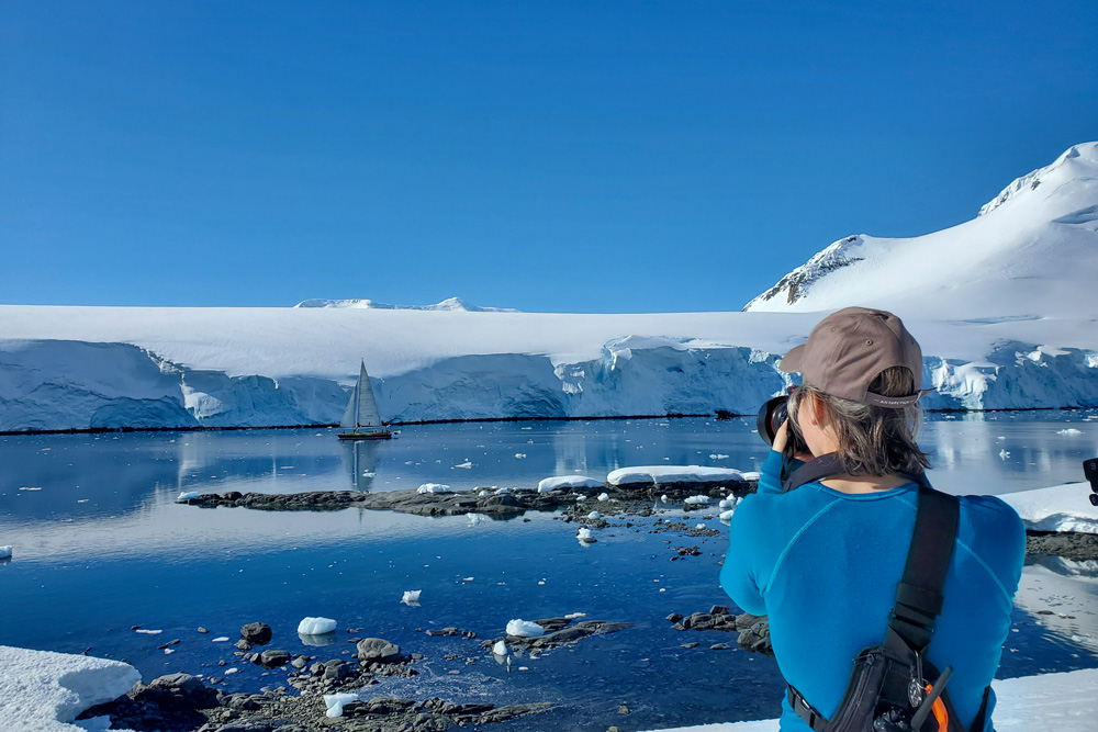 Lucy Bruzzone takes a photo of a yacht on a clear day