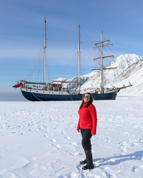 Katie standing in front of a tall ship