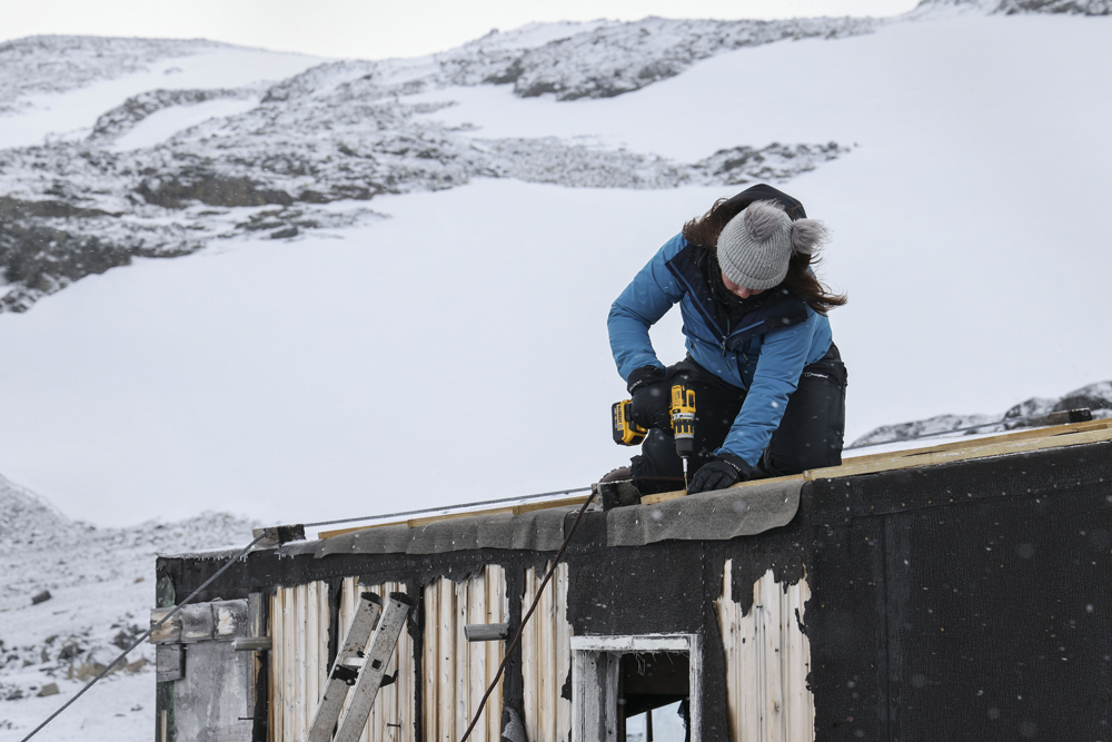 Ruth on the roof of Blaikock with a drill
