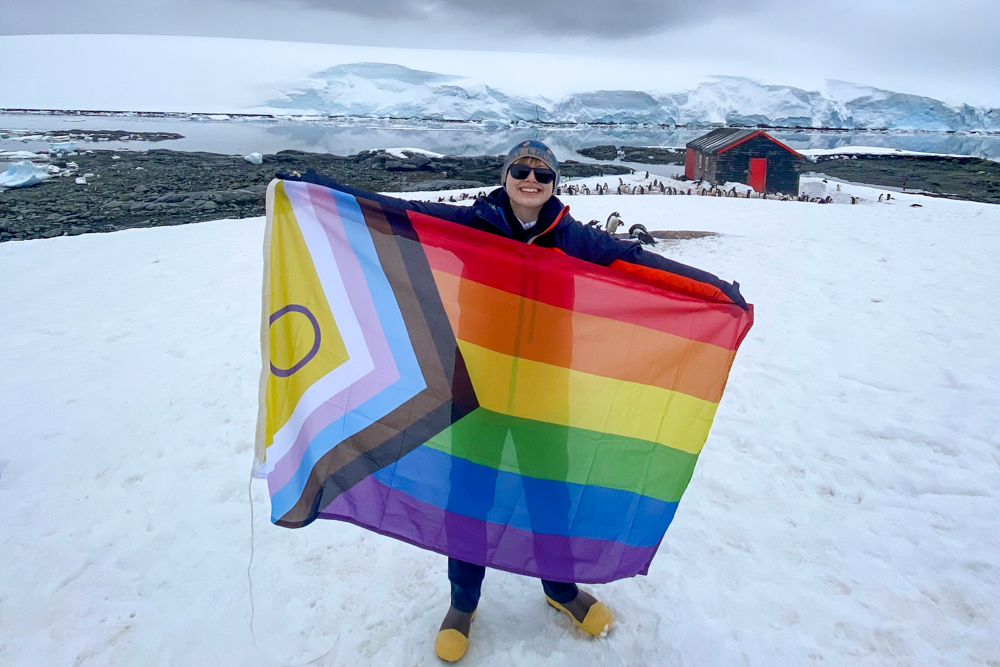 Aoife holds the flag up at Port Lockroy