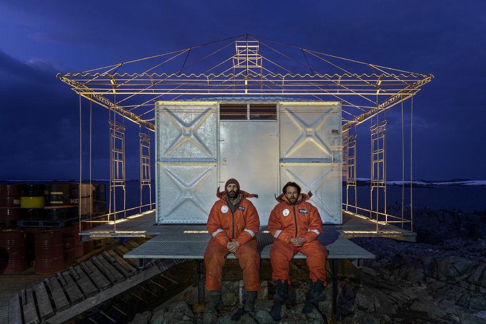 Slava & Dmytro sat in front of the installation at night