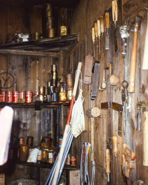 tools on the inside wall of the hut