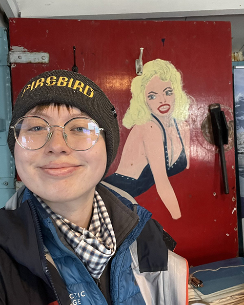 Aoife stands in front of the painting