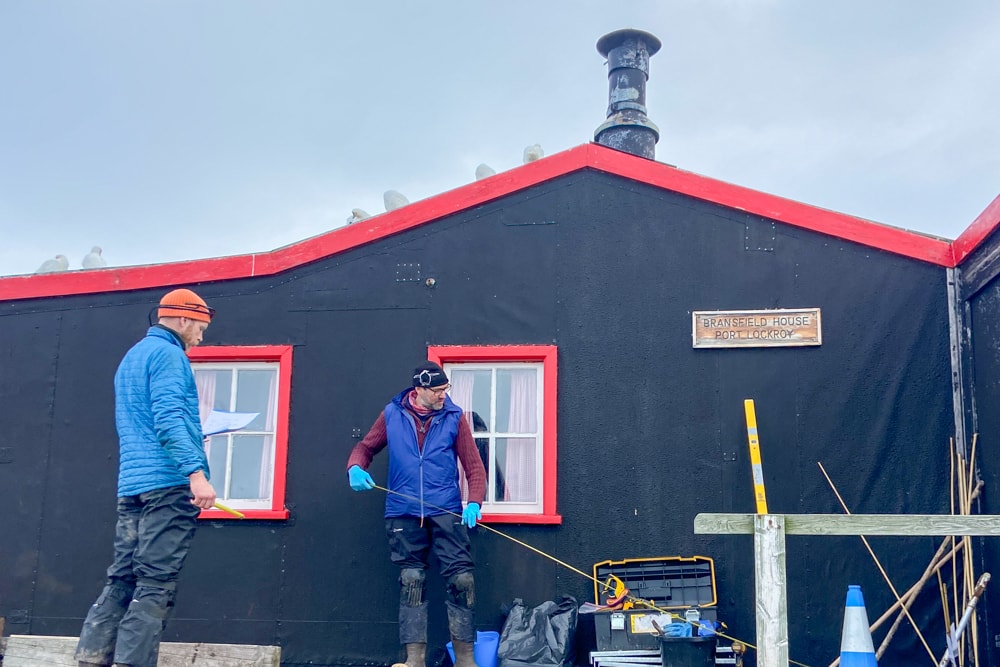 Two carpenters outside port lockroy