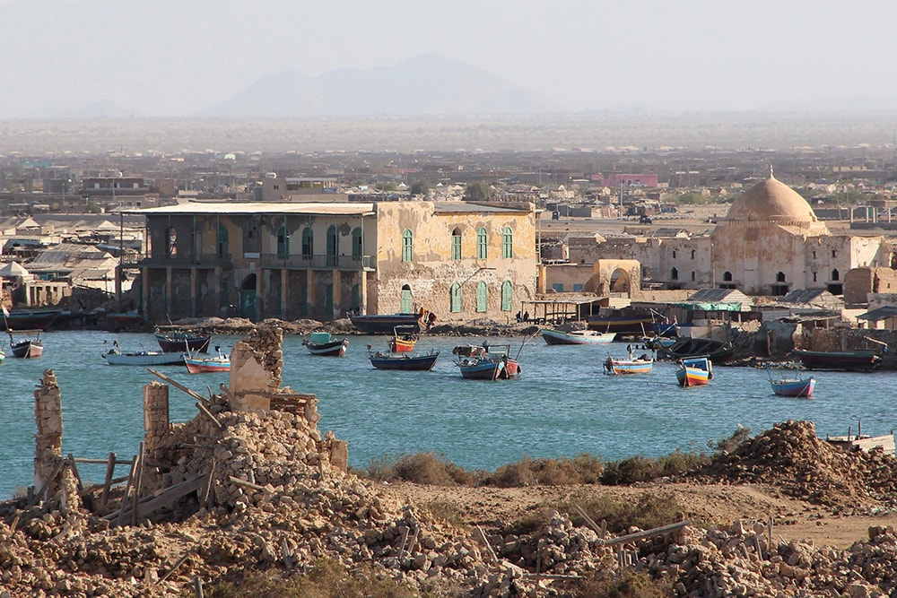 looking across a waterway at ruins in sudan
