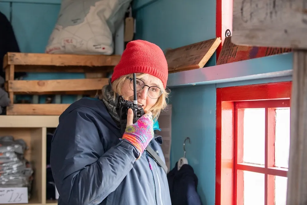 Lisa using a walkie talkie at port lockroy