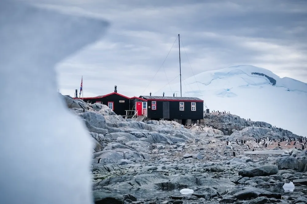 A red and black building behind an iceberg