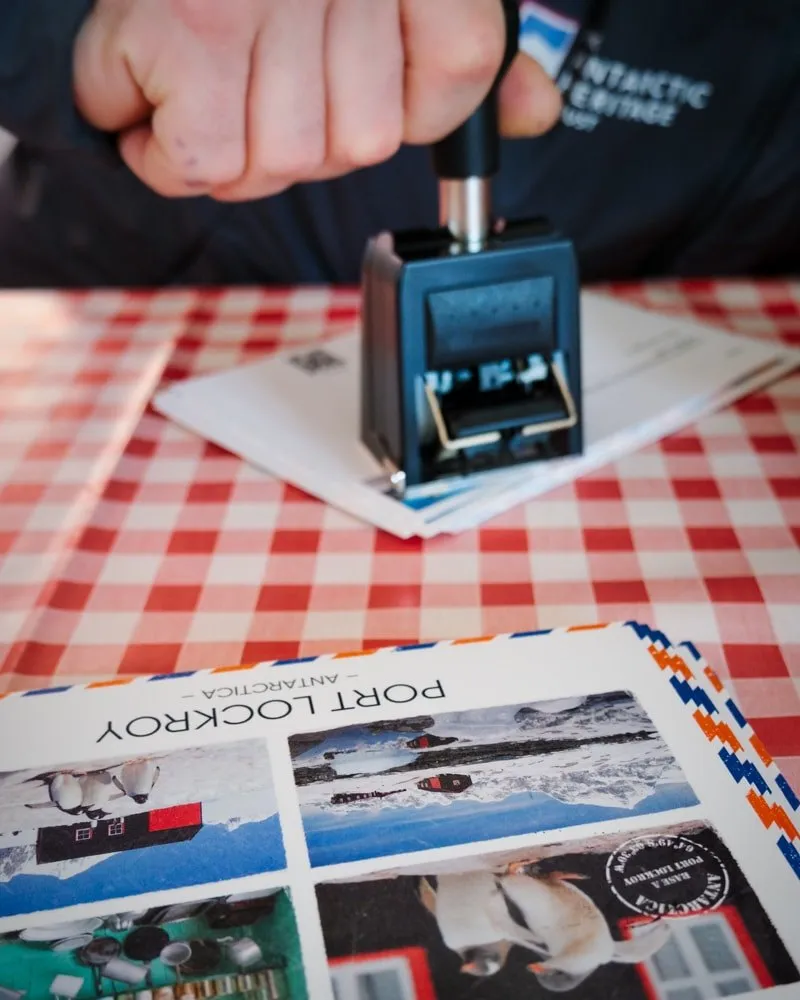 A close-up of Port Lockroy poostcard being stamped