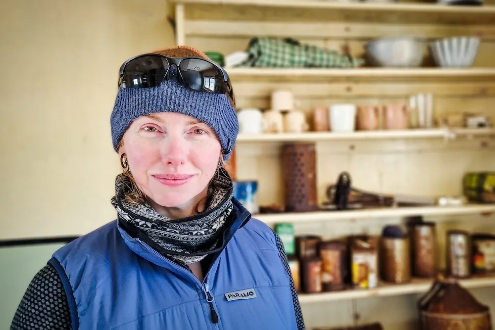 A portrait shot of Lesley inside a heritage hut